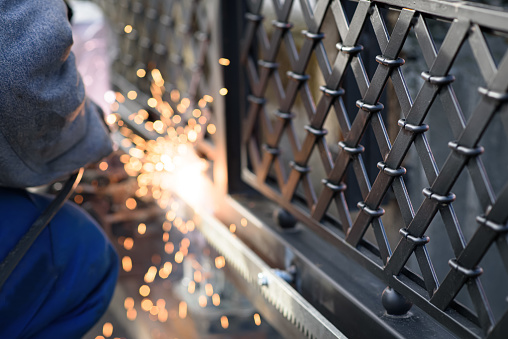 Welding at a fence installation with sparks